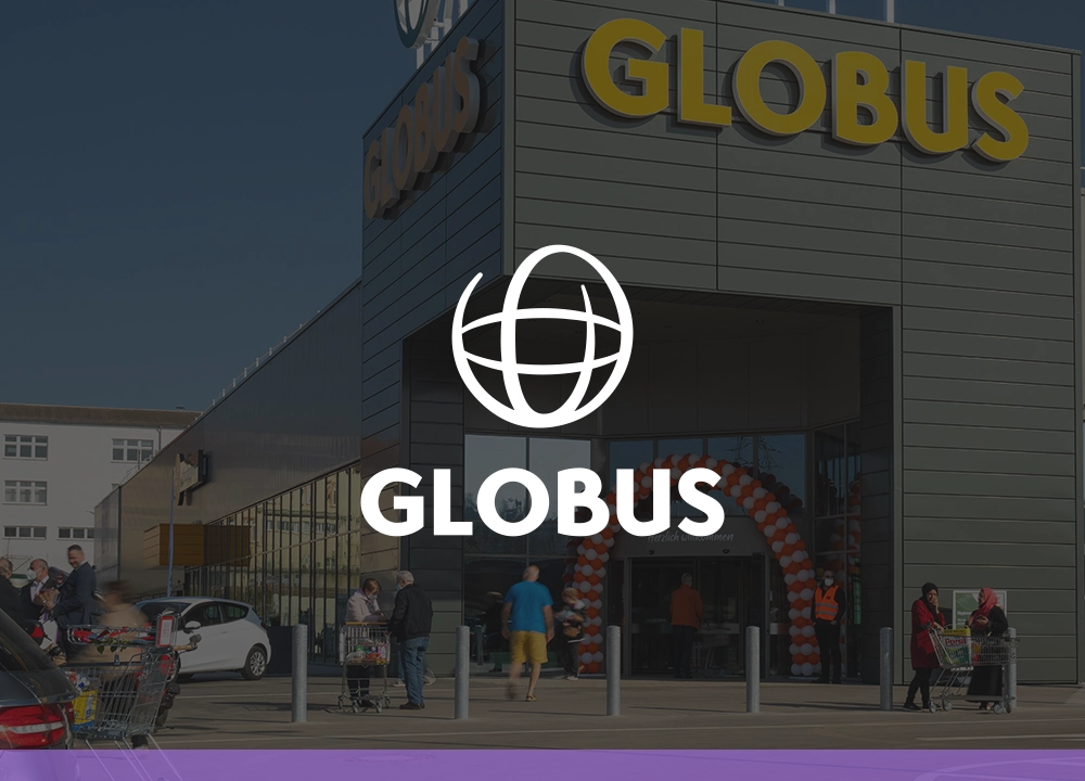 Eingang eines Globus-Marktes mit Kunden und Einkaufswagen, der zur Online-Shop-Lösung von FactFinder führt.
