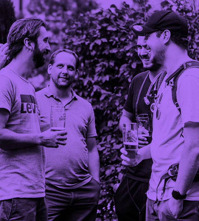 a group of men standing in front of a flowering tree